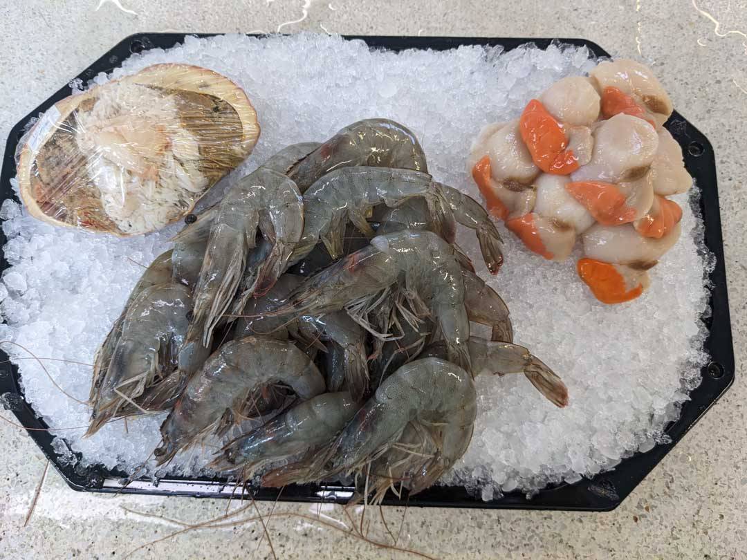 Dressed crab, raw prawns and scallops, packed cold for the door.